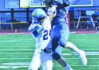 Sharyland Pioneer wide receiver Andrew Moss (85) leaps to haul in a pass from quarterback Jacob Rosales while McAllen Memorial defensive back Isagani Luistro (24) during Friday night’s game at Sharyland Pioneer. The visiting Mustangs won, 42-24.