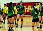 PSJA Memorial’s Kristi Gomez (4) celebrates with her team after a kill during a match earlier this season against Donna. Kristi and her sister Deserey Gomez have led the Lady Wolverines this year into contention for a district title.
